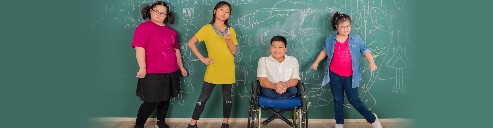 Portrait group of young disabled student standing in front of chalkboard